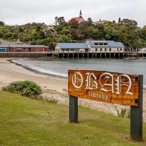 The sign for Oban Township stands at the entrance to the beach on Stewart Island