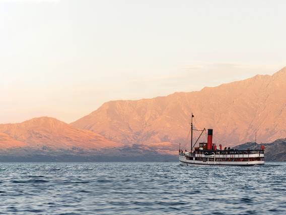 The Tss Earnslaw sails in front of the Remarkables