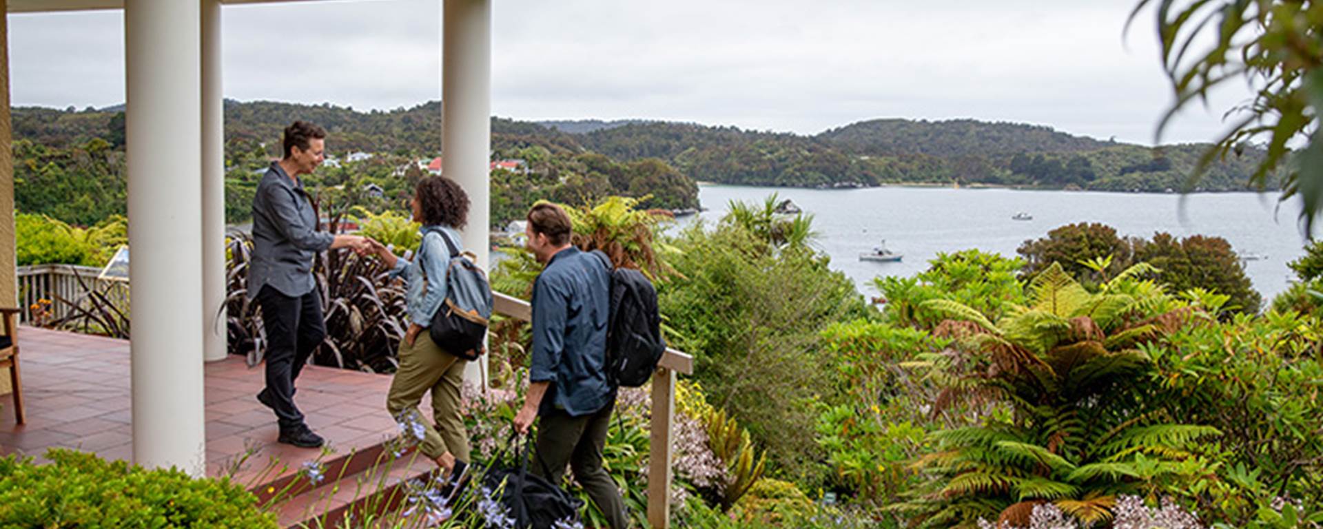 A couple being welcomed outside the Stewart Island Lodge