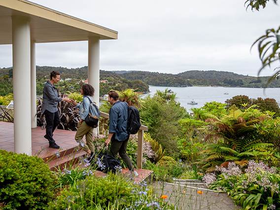 A couple being welcomed outside the Stewart Island Lodge