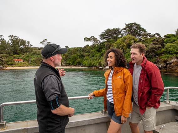 Couple chats to a local guide on the Ulva Island explorer ferry