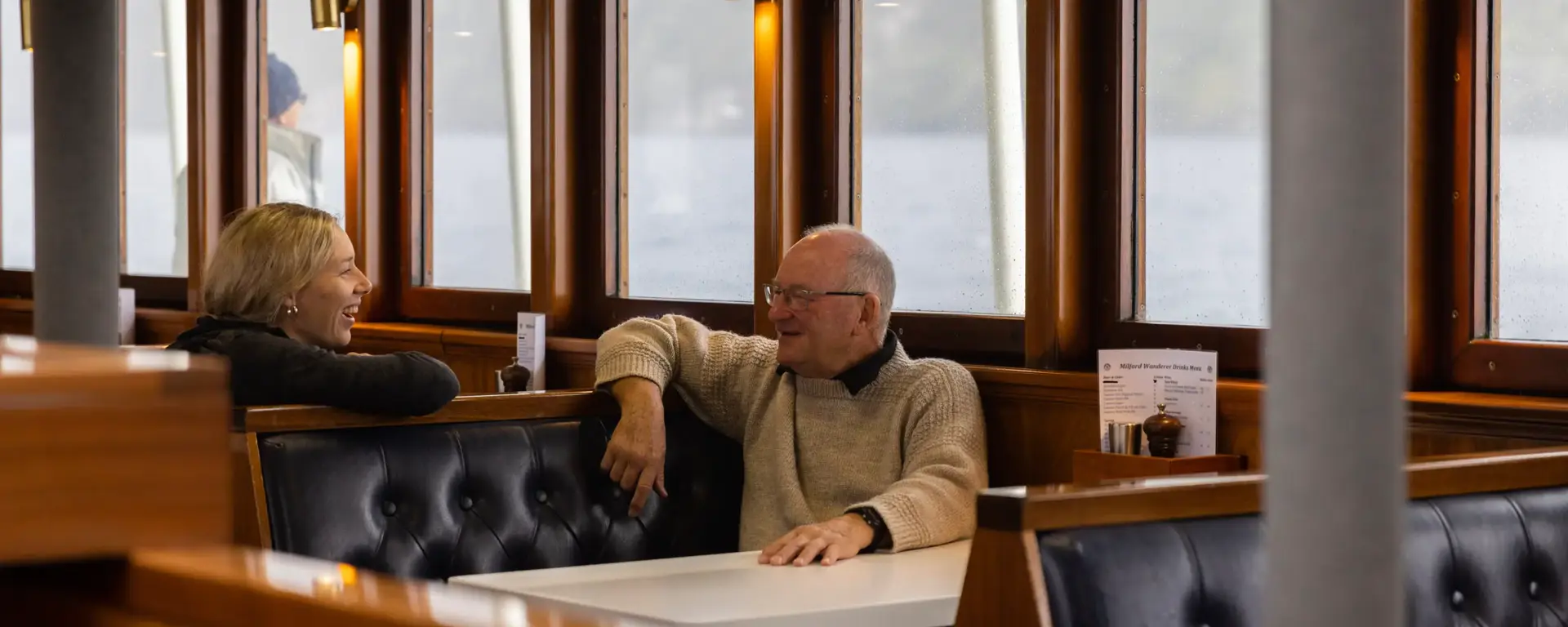Guests relaxing inside the lounge of an expedition vessel.