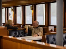 Guests relaxing inside the lounge of an expedition vessel.