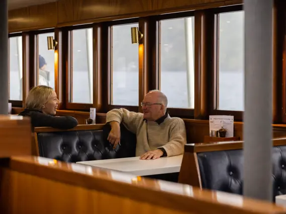 Guests relaxing inside the lounge of an expedition vessel.