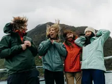 Group of friends laughing together on a Milford Sound cruise.