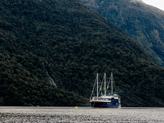 A traditional overnight cruise vessel anchored in an arm of Doubtuful Sound,