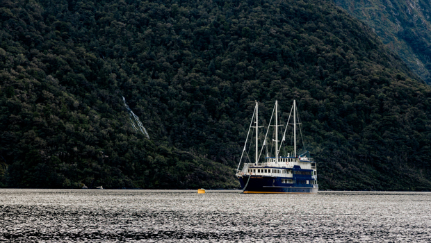 A traditional overnight cruise vessel anchored in an arm of Doubtuful Sound,