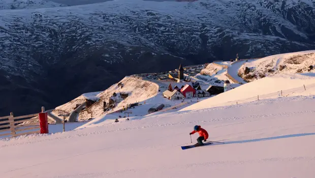 Skier descending a snowy slope at Cardrona Alpine Resort.