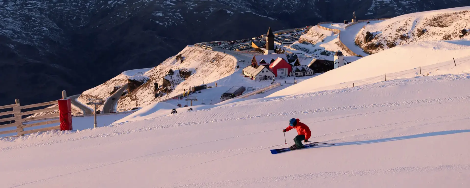 Skier descending a snowy slope at Cardrona Alpine Resort.