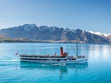 The TSS Earnslaw cruises across Lake Wakatipu with Remarkables in the background