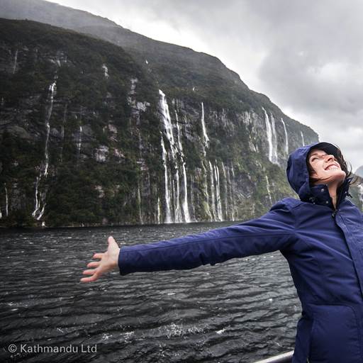 Woman enjoying the waterfalls in Fiordland National Park