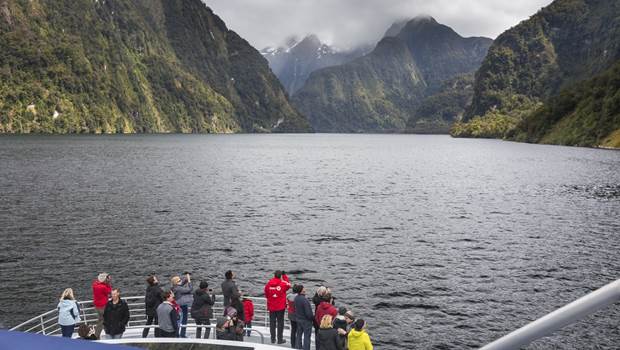 Group of tourists cruising through Doubtful Sound on a Wilderness Day Cruise