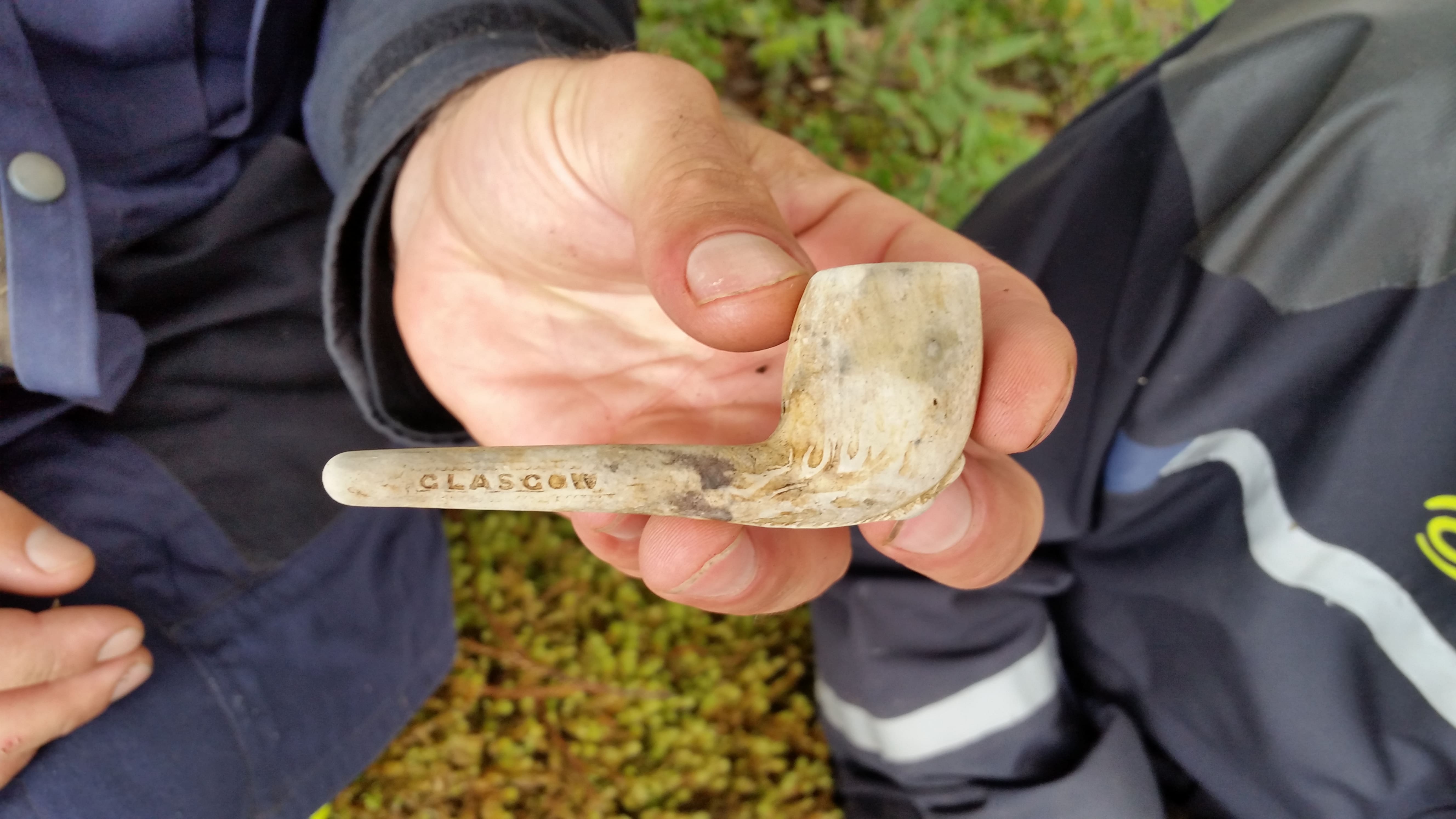Historic clay smoker's pipe in hand