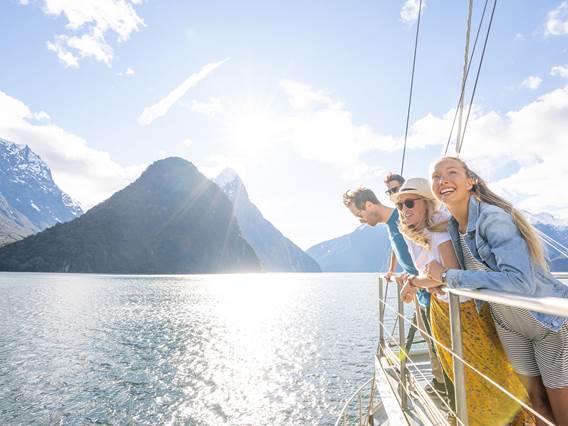 Group of friends on a cruise in Milford Sound on a sunny day