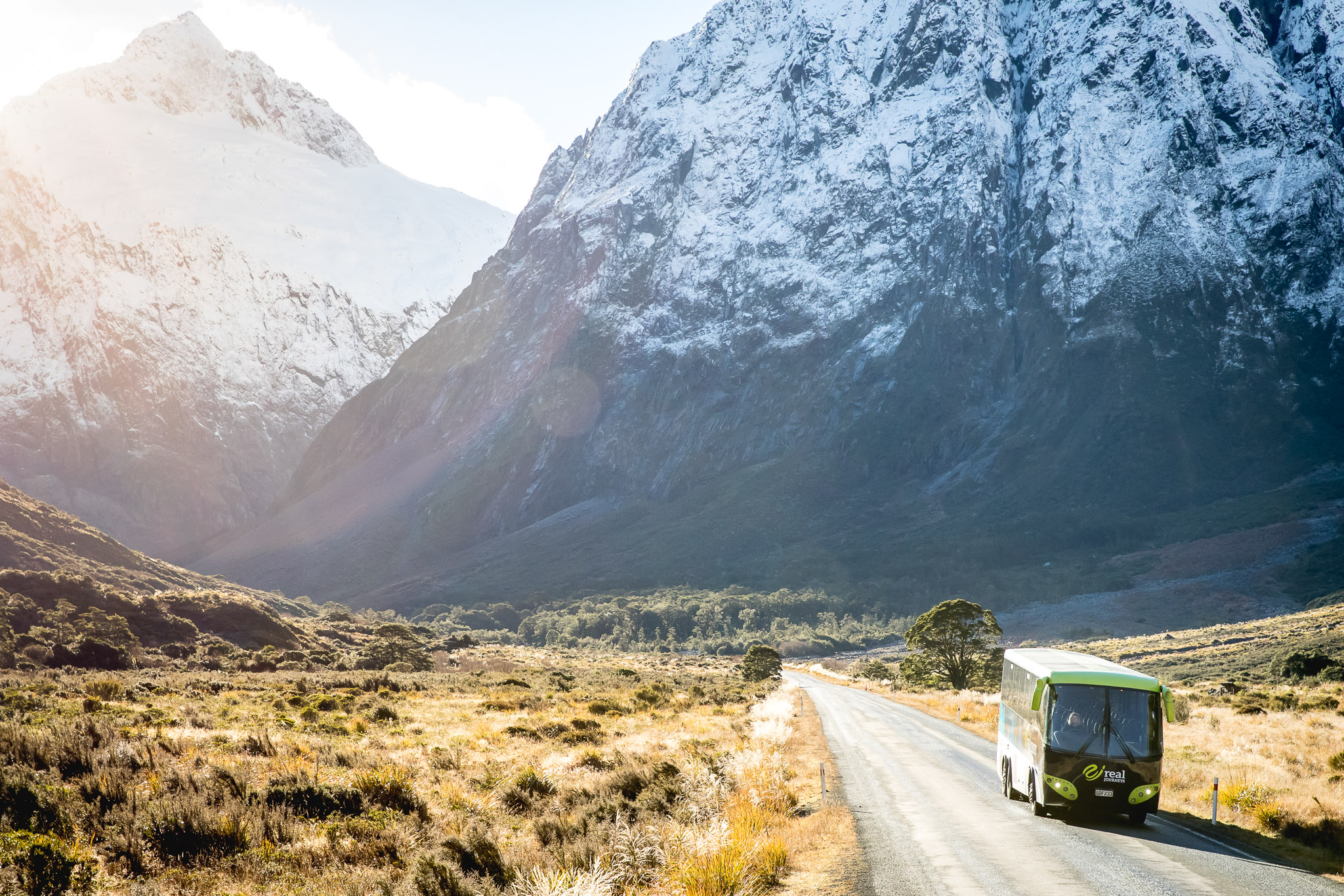 Coach on the way to Milford Sound with snow capped mountains