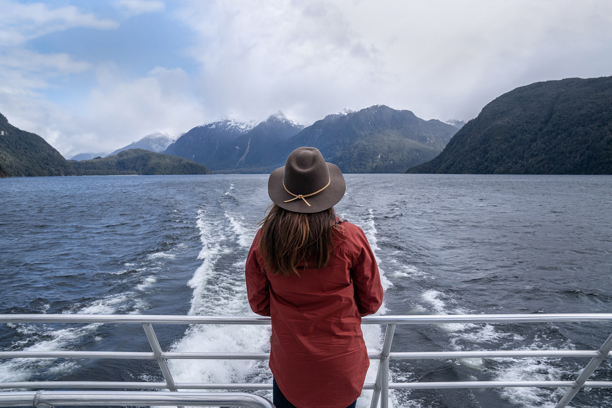 Girl looking out from boat on Lake Manapouri