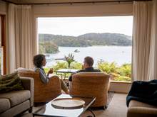 Couple enjoying the view from the lounge at Stewart Island Lodge