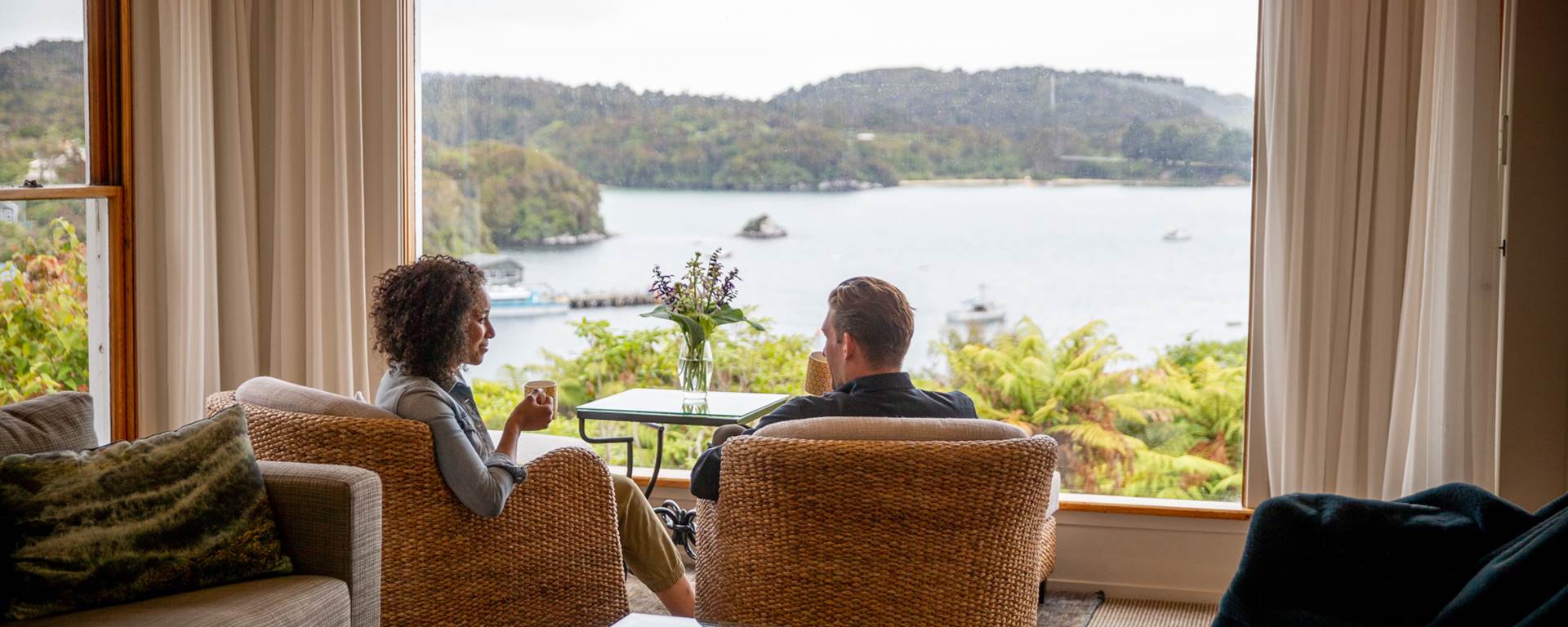 Couple enjoying the view from the lounge at Stewart Island Lodge