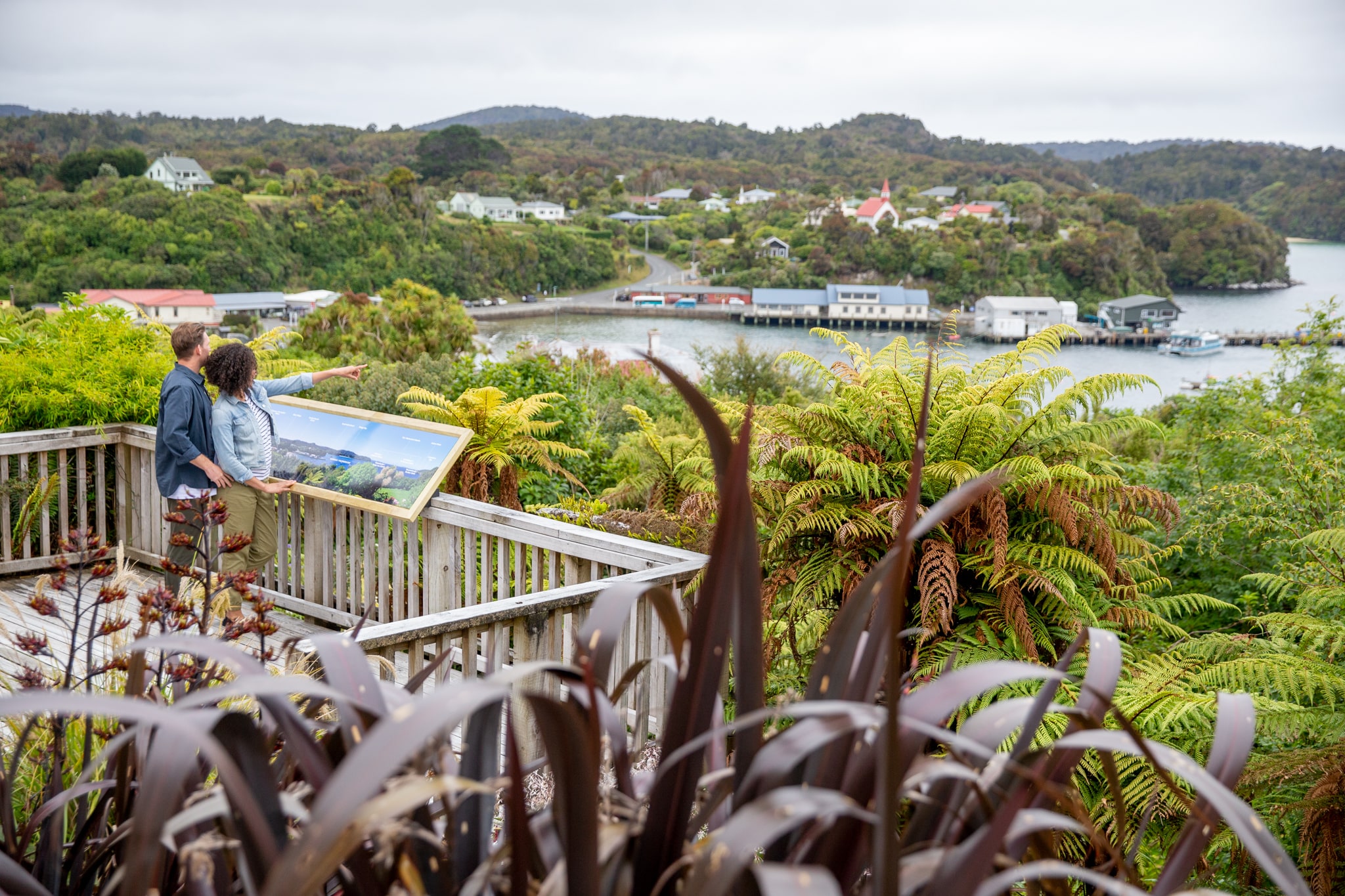 Couple checking out the view over Oban on the deck at Stewart Island Lodge