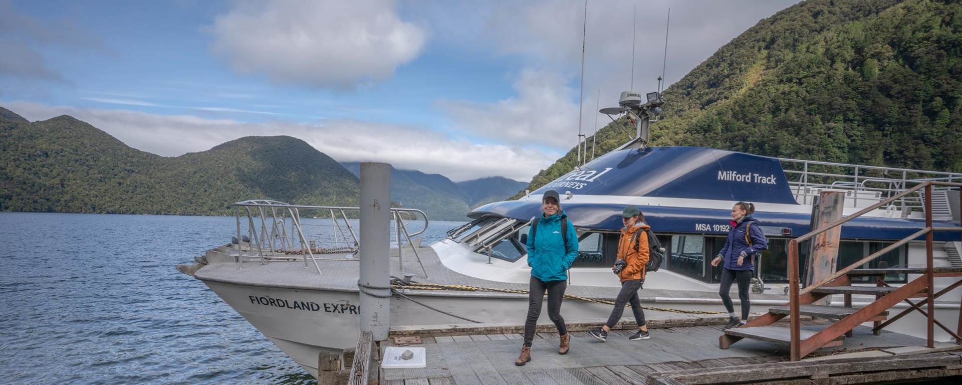 Walkers disembarking boat at Glade Wharf to start the Milford Track