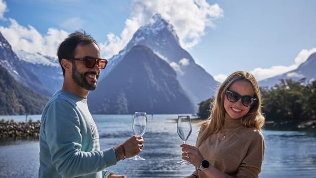 Couple with champagne with Mitre Peak in the background