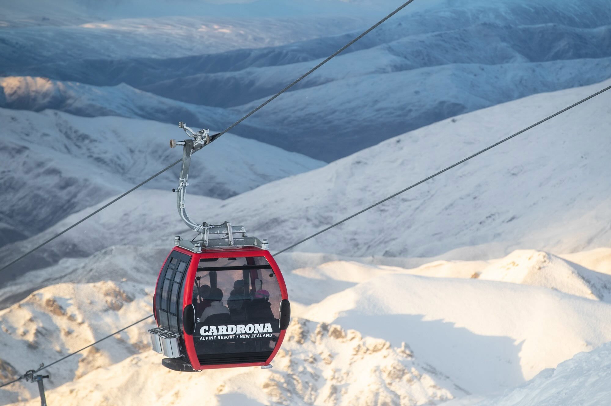 Gondola heading up a snowy mountain