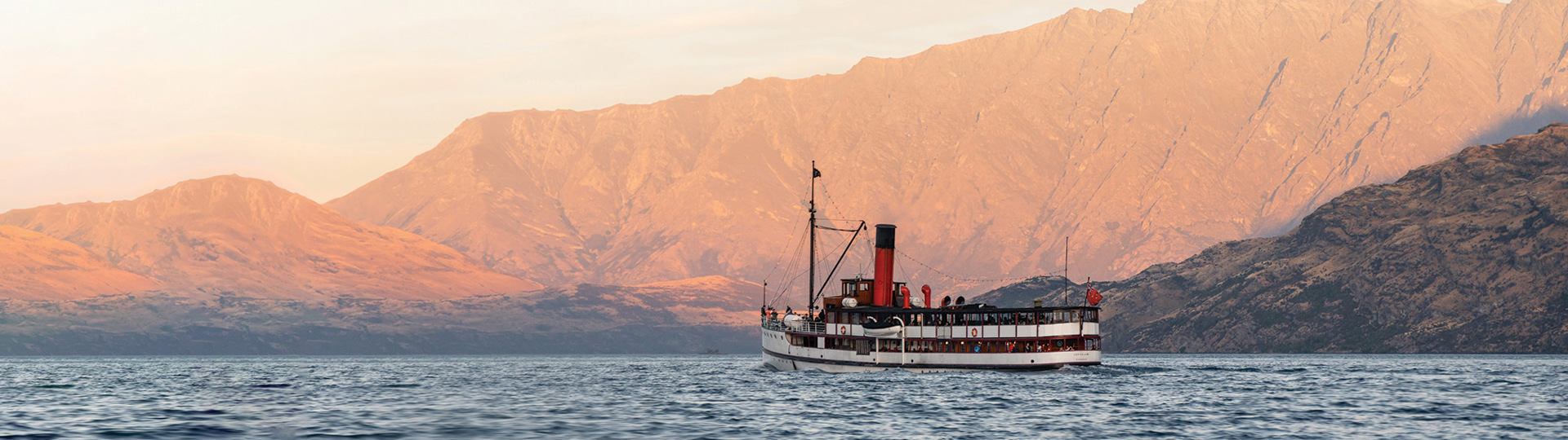 The Tss Earnslaw sails in front of the Remarkables
