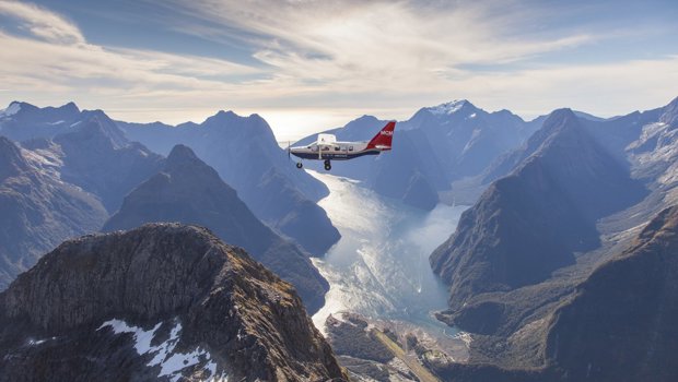 Plane flys over Milford Sound