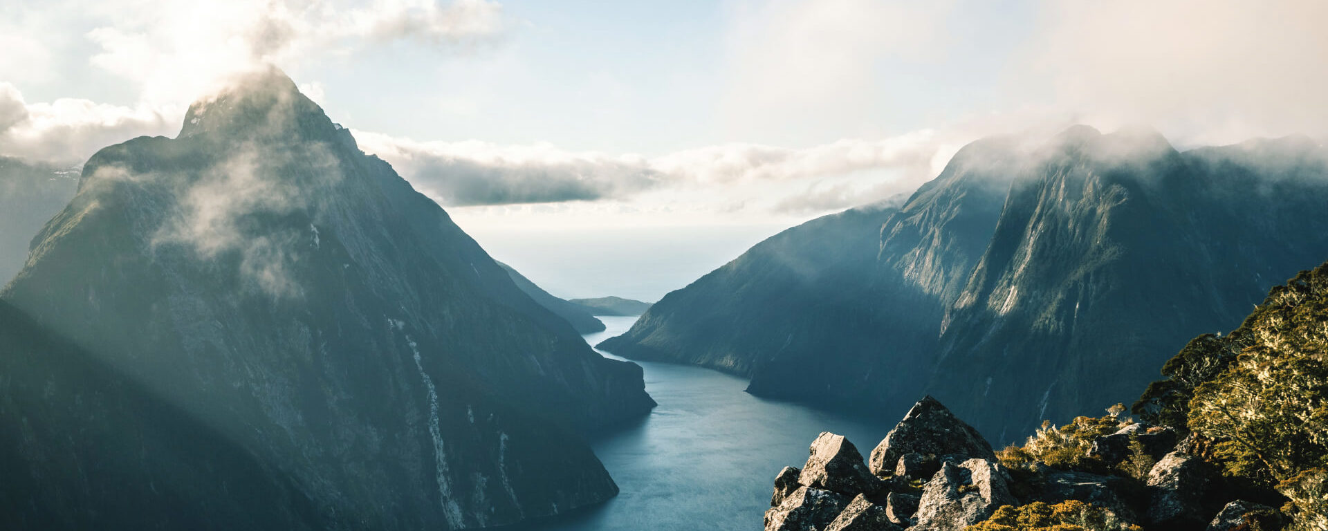 An aerial view of Milford Sound winding out to the Tasman Sea through its towering mountains.