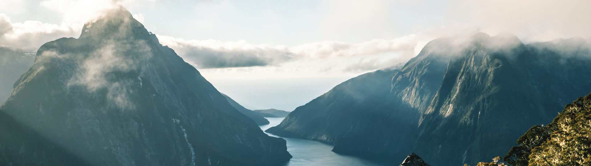 An aerial view of Milford Sound winding out to the Tasman Sea through its towering mountains.