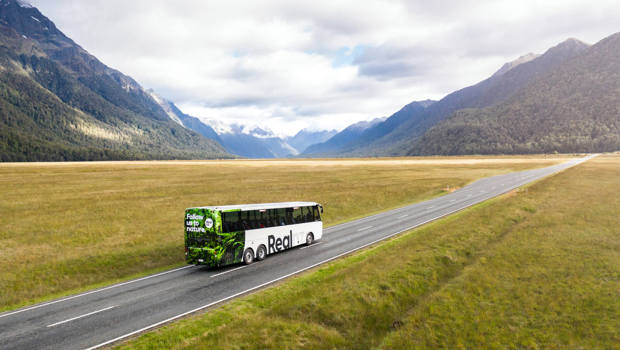 A bus drives through the Eglinton Valley on its way to Milford Sound.
