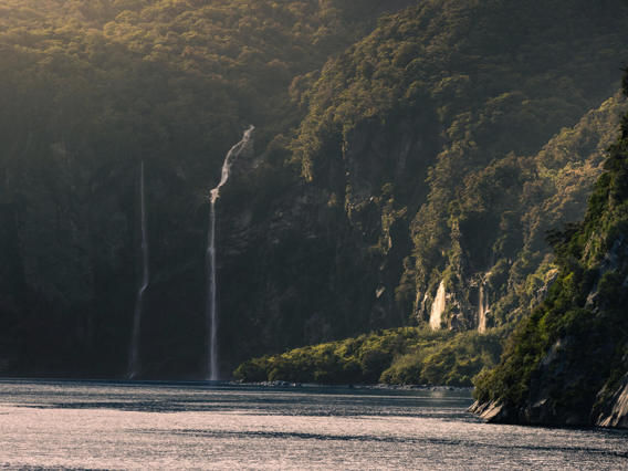 A panoramic photo of Milford Sound with waterfalls cascading into the fiord.
