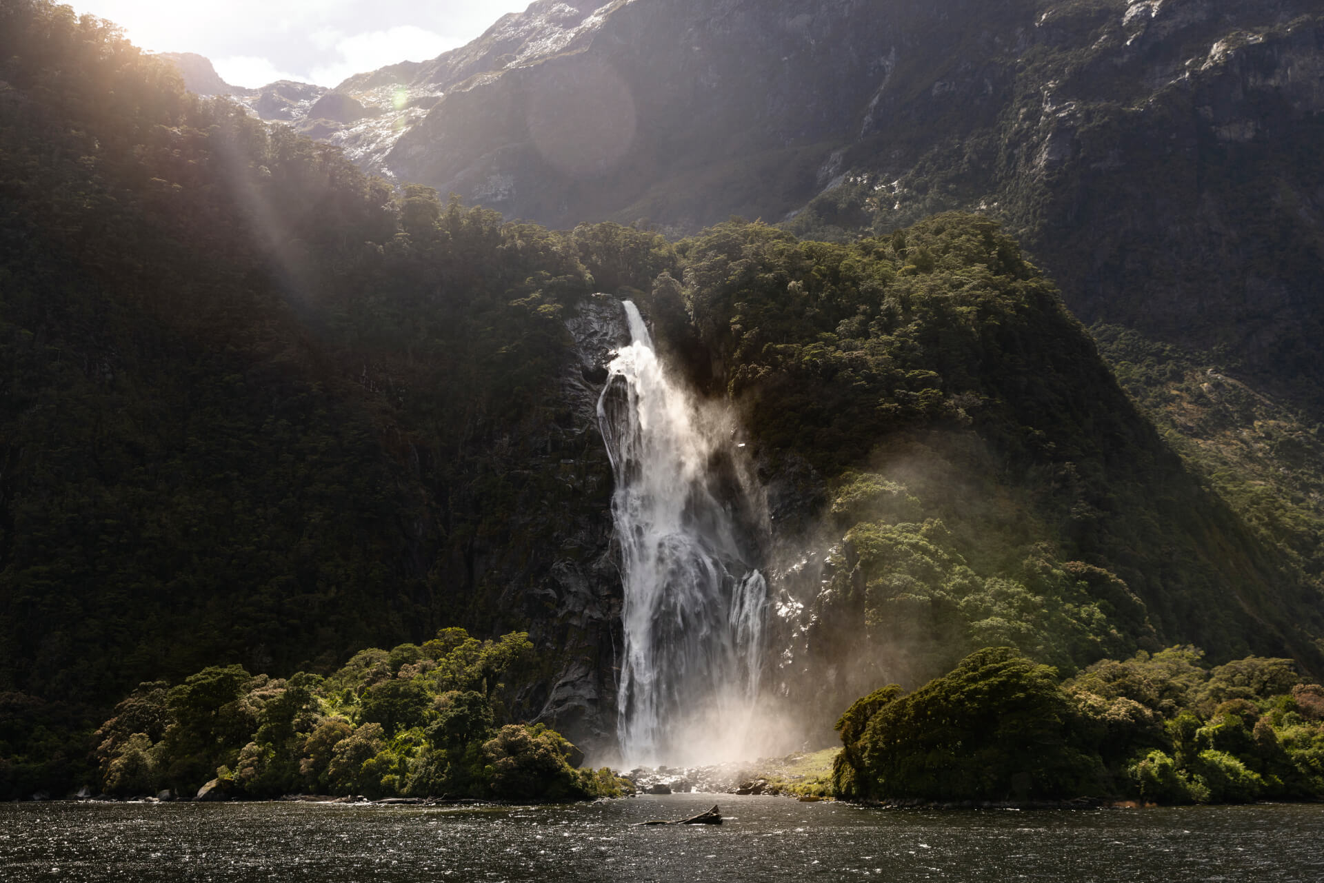 The mighty Bowen Falls thunders down a cliff face and into the ocean beneath.