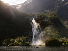The mighty Bowen Falls thunders down a cliff face and into the ocean beneath.