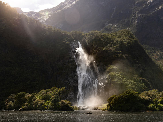 The mighty Bowen Falls thunders down a cliff face and into the ocean beneath.