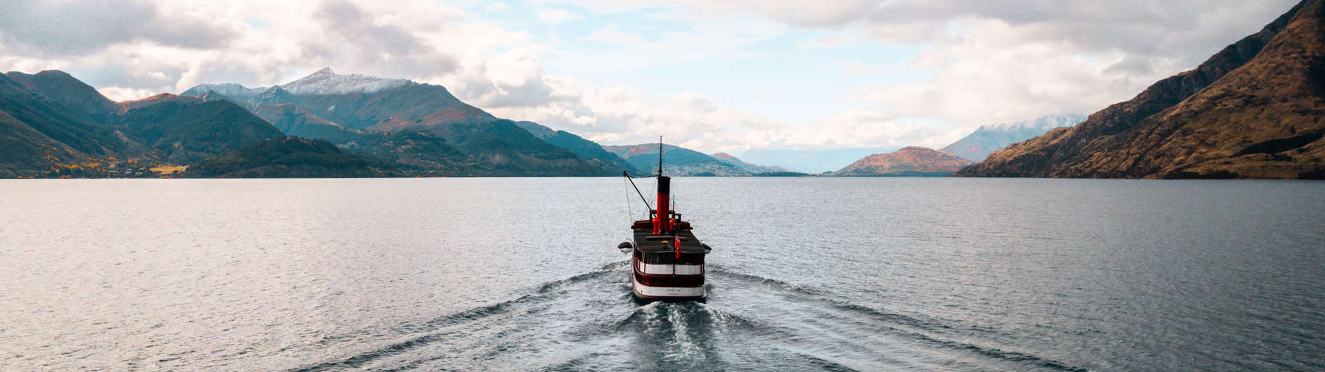 The historic TSS Earnslaw steamship cruises across the lake back to Queenstown at sunset.