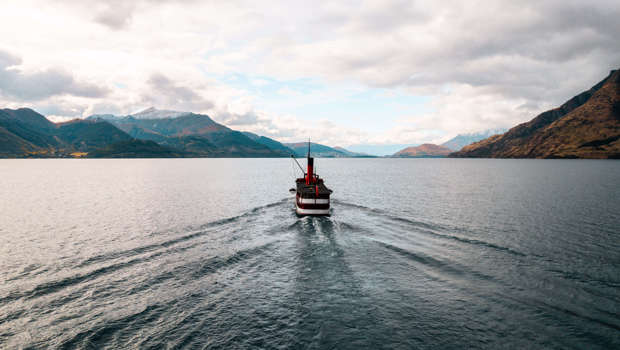 The historic TSS Earnslaw steamship cruises across the lake back to Queenstown at sunset.
