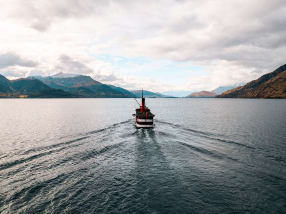 The historic TSS Earnslaw steamship cruises across the lake back to Queenstown at sunset.