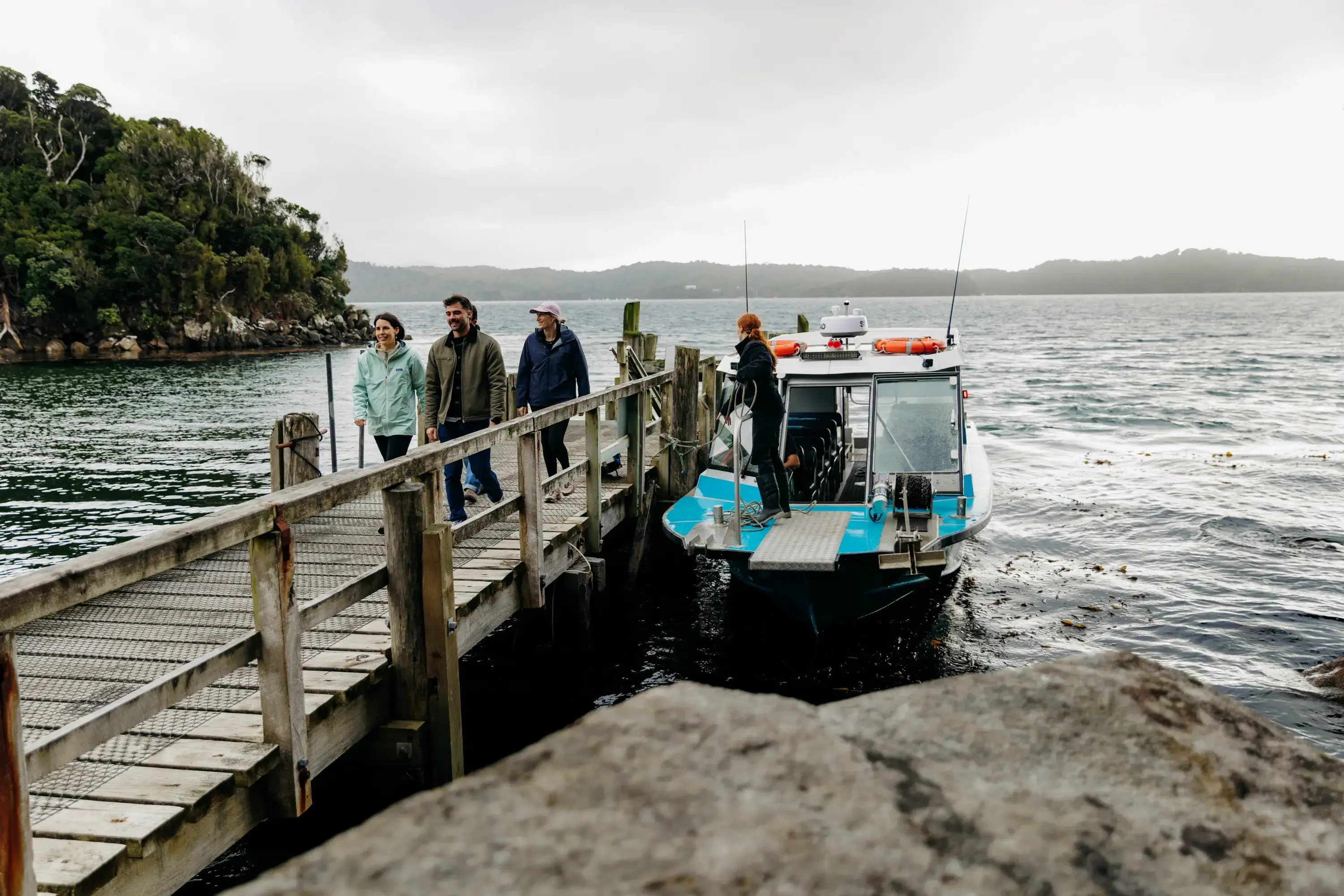 A group of friends arrive on Ulva Island via water taxi. 