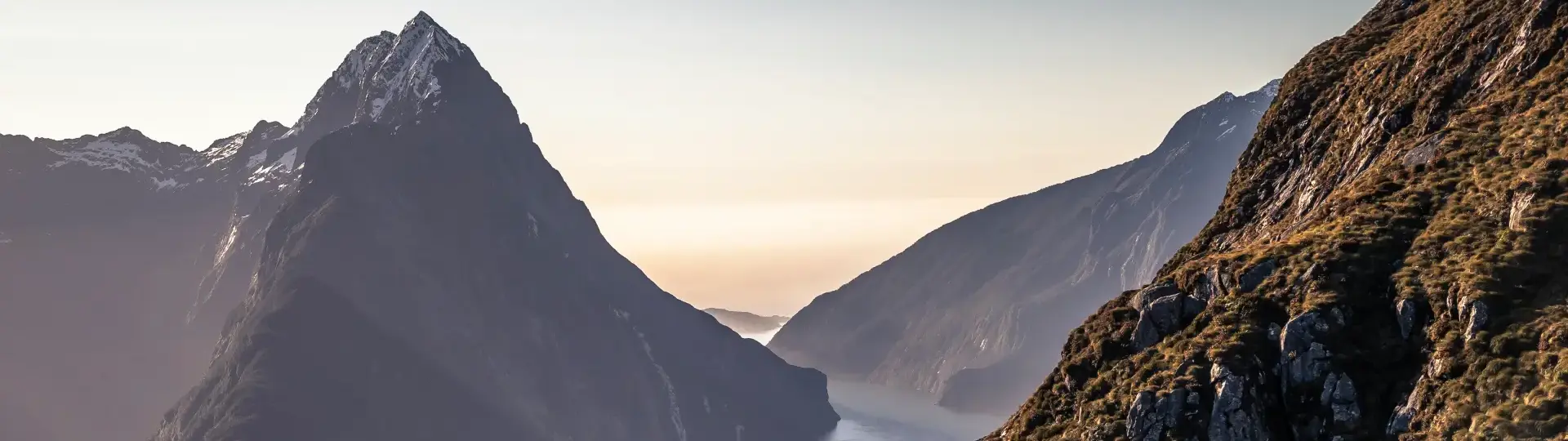 A scenic view of Milford Sound from above as the sun sets.