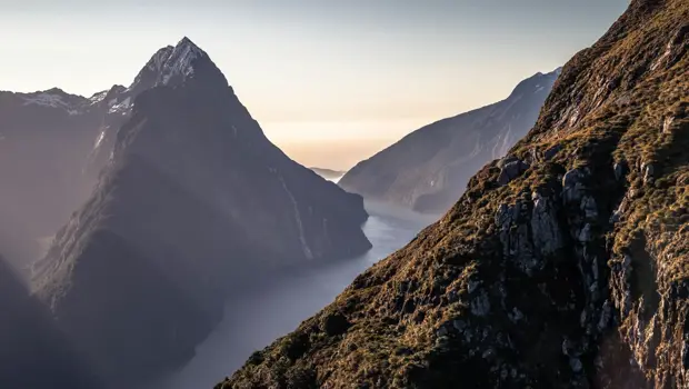 A scenic view of Milford Sound from above as the sun sets.