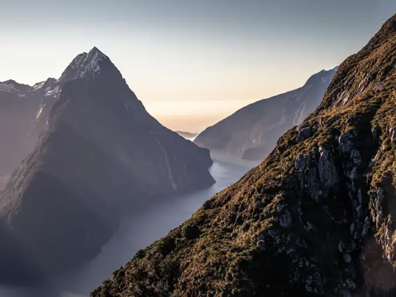 A scenic view of Milford Sound from above as the sun sets.