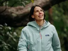 Guest walking through lush native forest.