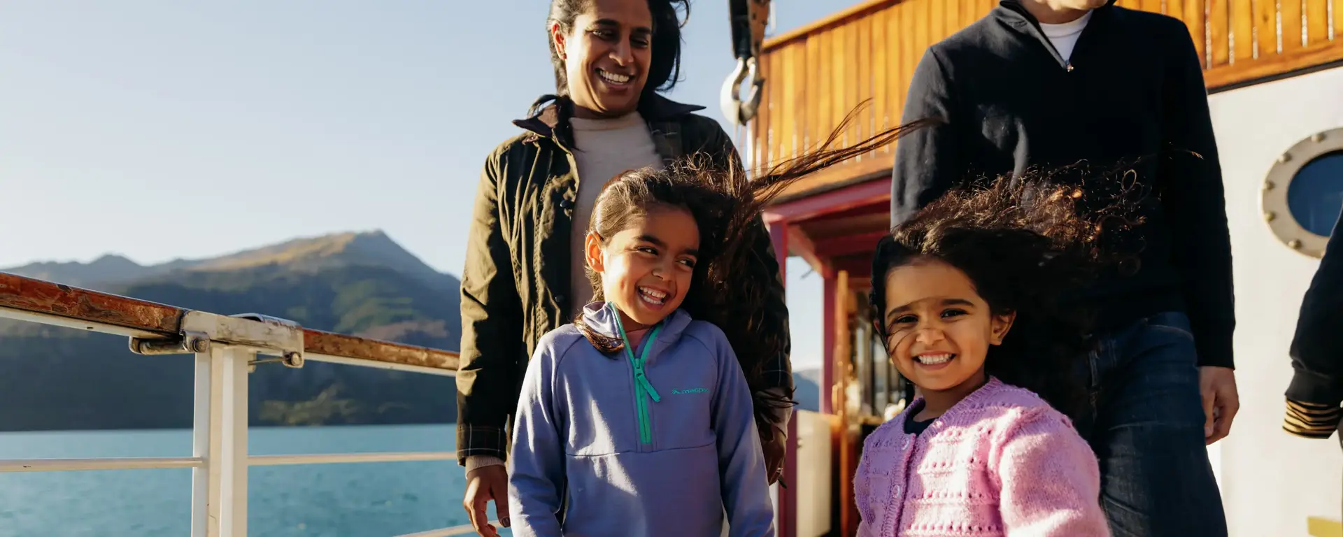 Family enjoying lake and mountain views from a cruise to Walter Peak.