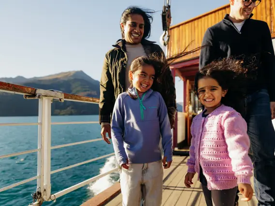 Family enjoying lake and mountain views from a cruise to Walter Peak.