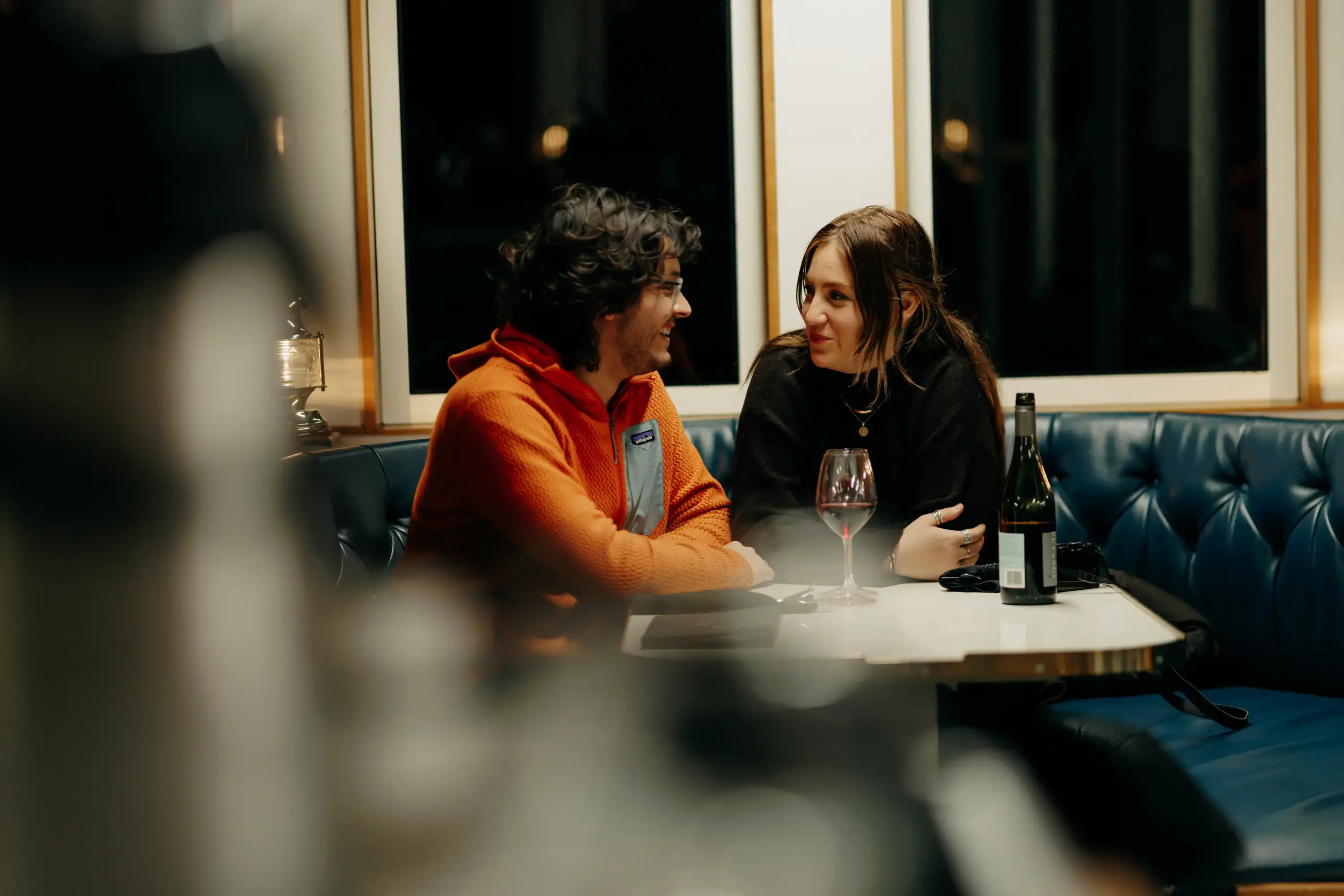 Two guests chatting over a meal aboard an overnight cruise.