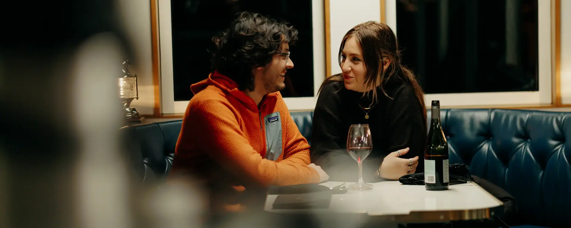 Two guests chatting over a meal aboard an overnight cruise.