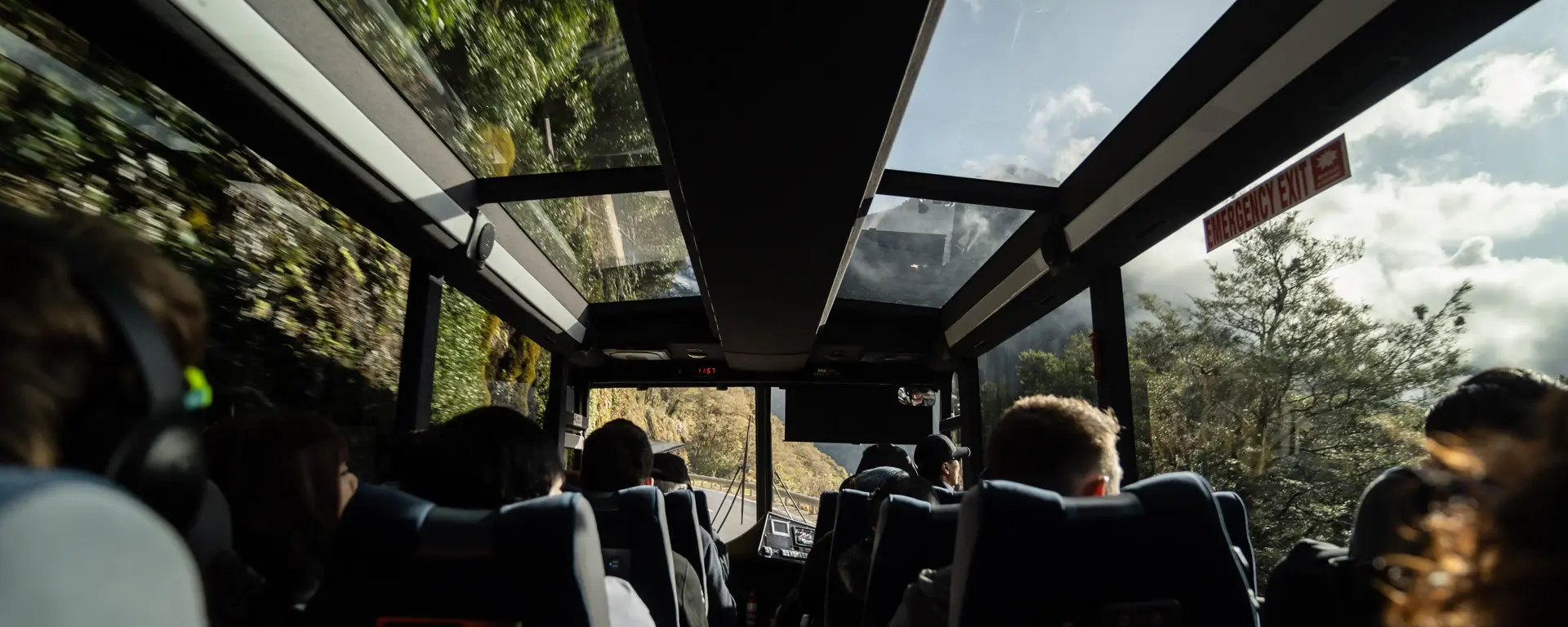 Passengers taking in mountain views from inside a coach.