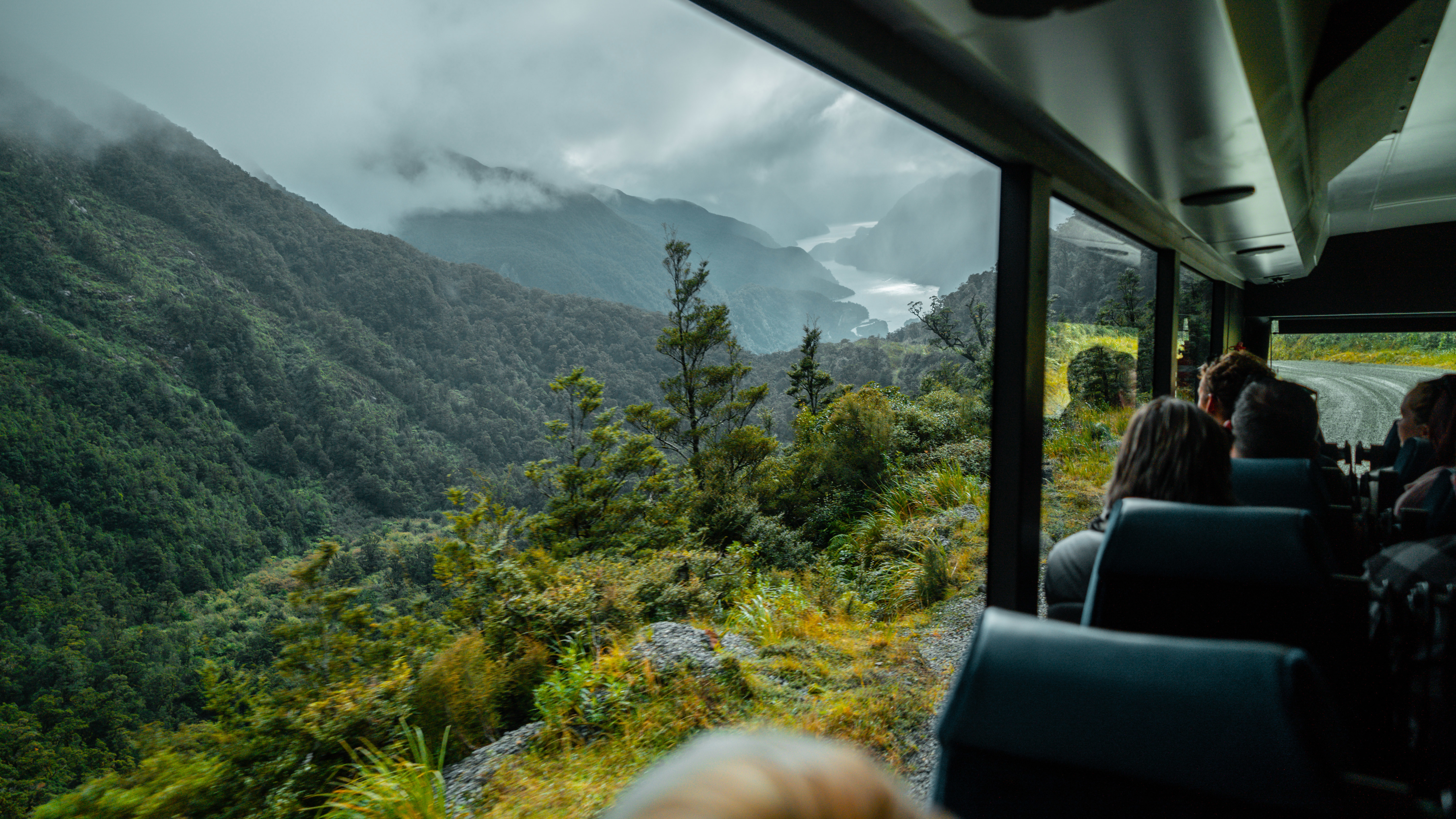 A view of Doubtful Sound seen out the window of a bus travelling over the Wilmot Pass road on a RealNZ experience.