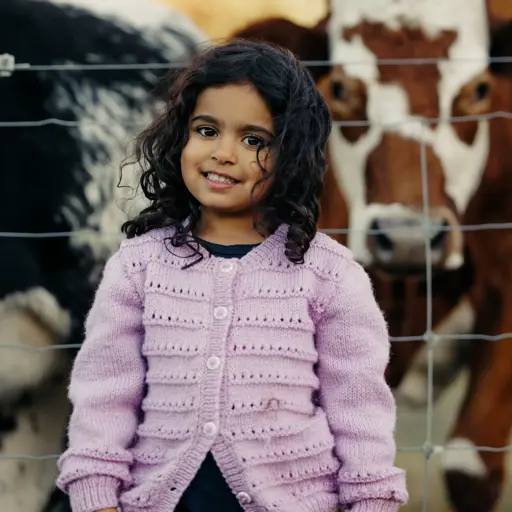 Young child visiting the animals at Walter Peak Farm.